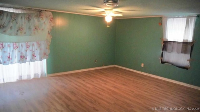 unfurnished room with hardwood / wood-style flooring, ornamental molding, and ceiling fan