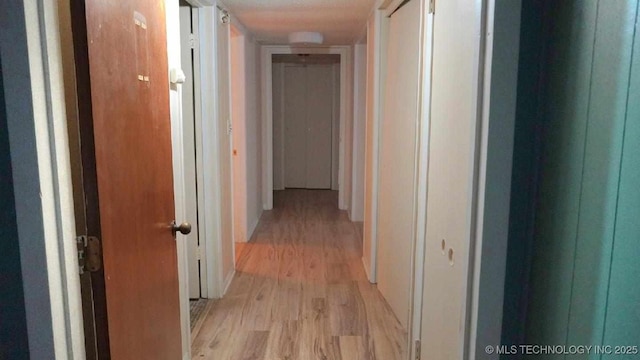 hallway with light wood-type flooring