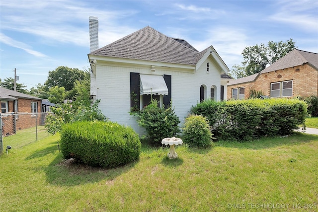 view of side of property with a lawn