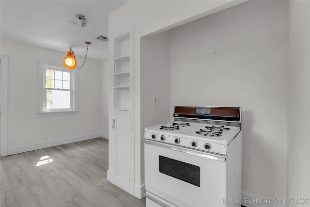 kitchen featuring light hardwood / wood-style flooring and gas range gas stove