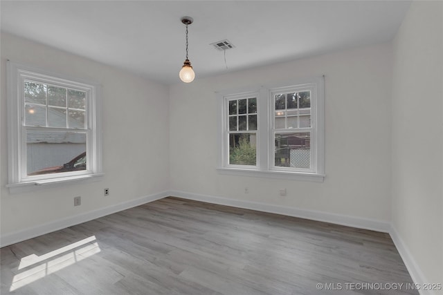 unfurnished room with hardwood / wood-style flooring