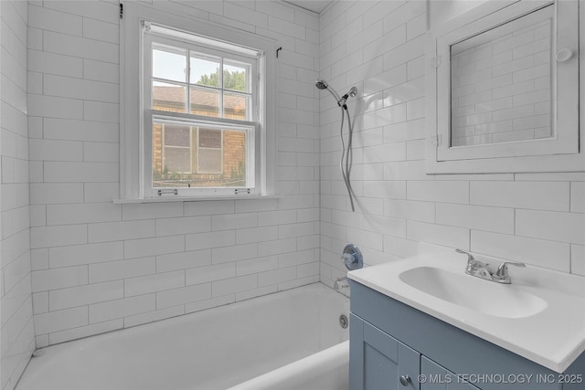 bathroom featuring vanity and tiled shower / bath