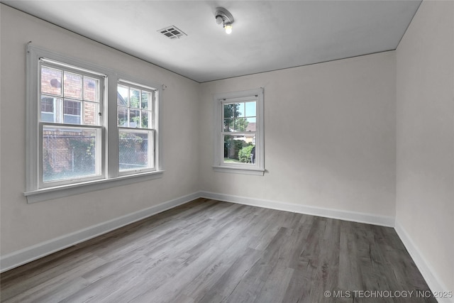 spare room with wood-type flooring