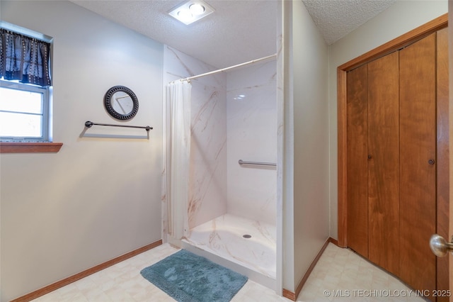 bathroom featuring walk in shower and a textured ceiling