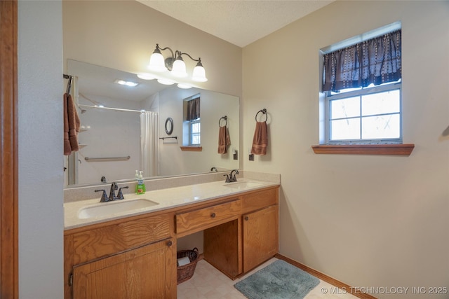 bathroom featuring vanity, a textured ceiling, and a shower with shower curtain