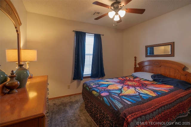 bedroom featuring ceiling fan, a textured ceiling, and dark colored carpet