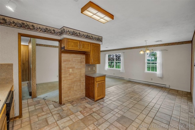 kitchen featuring pendant lighting, an inviting chandelier, and a baseboard heating unit