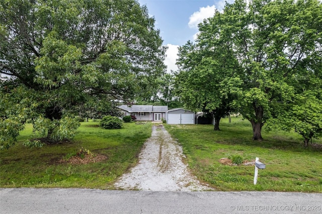 view of front of house featuring a garage and a front lawn