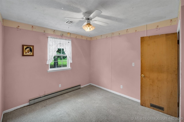 carpeted spare room with baseboard heating, ceiling fan, and a textured ceiling