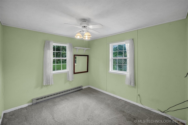 carpeted empty room with a textured ceiling, plenty of natural light, ceiling fan, and baseboard heating