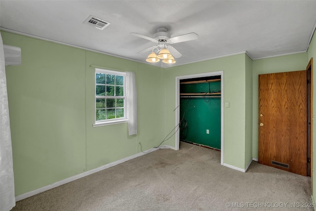 unfurnished bedroom with light carpet, ceiling fan, and a closet