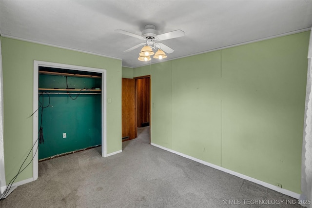 unfurnished bedroom featuring light colored carpet, ceiling fan, and a closet