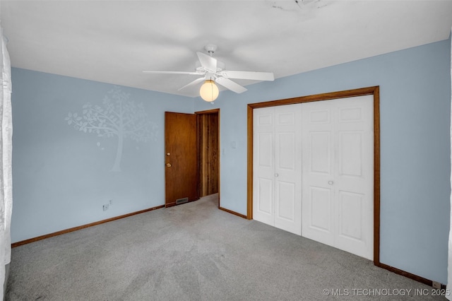 unfurnished bedroom featuring ceiling fan, carpet flooring, and a closet