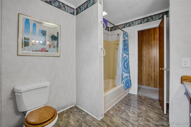 bathroom featuring shower / bath combination with curtain and toilet