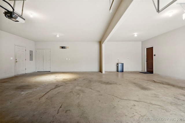 garage with a garage door opener and electric panel