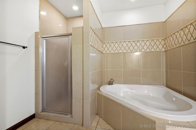 bathroom with tile patterned floors, independent shower and bath, and tile walls