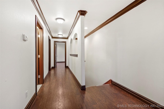 corridor with ornamental molding and dark hardwood / wood-style floors