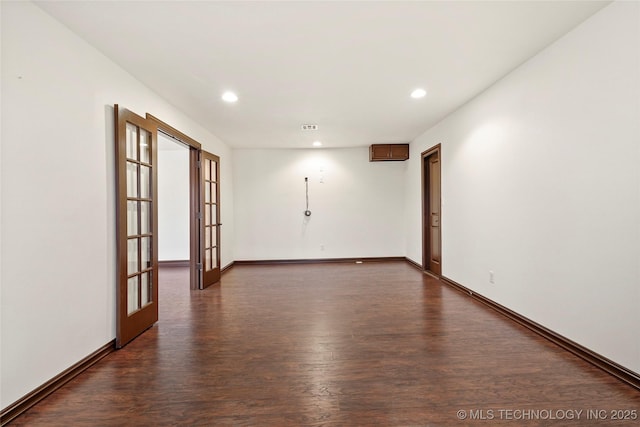 unfurnished room with dark hardwood / wood-style flooring and french doors