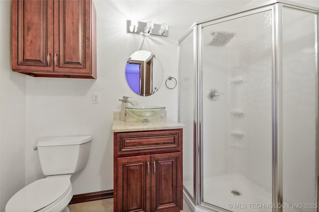 bathroom featuring vanity, toilet, and a shower with shower door