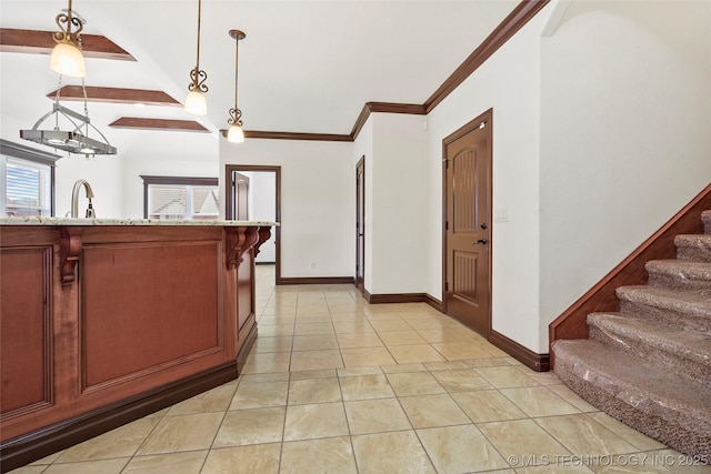 tiled entrance foyer featuring sink and ornamental molding