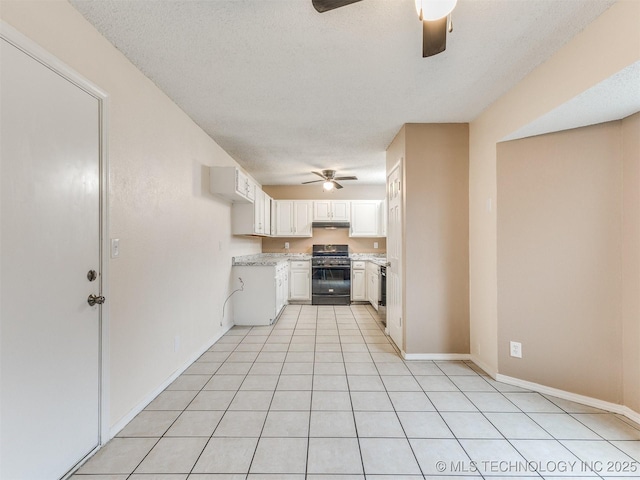 kitchen with gas range, white cabinetry, ceiling fan, and a textured ceiling