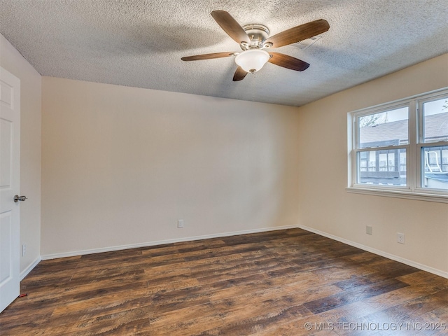 empty room with ceiling fan, dark hardwood / wood-style floors, and a textured ceiling