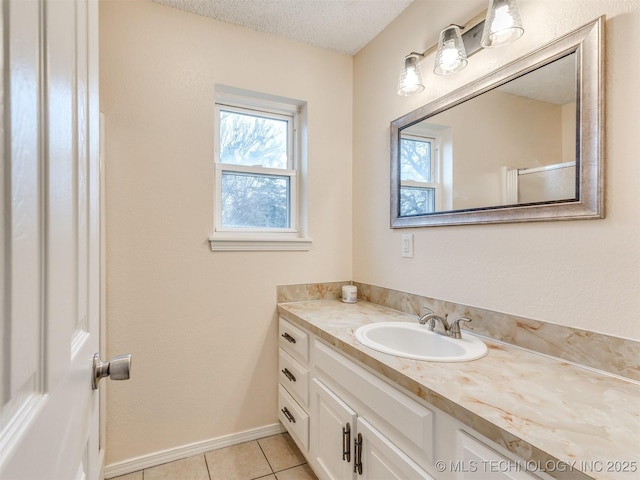 bathroom featuring vanity, tile patterned flooring, and a textured ceiling