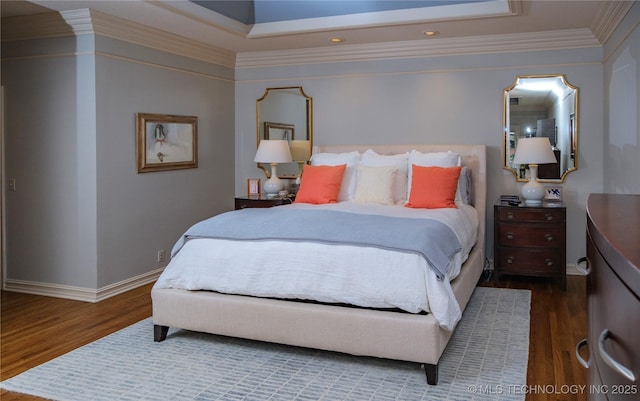 bedroom with dark hardwood / wood-style flooring and ornamental molding