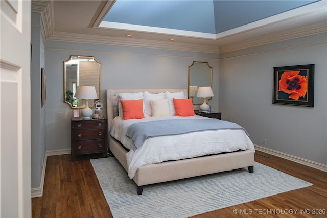 bedroom with ornamental molding and dark hardwood / wood-style floors