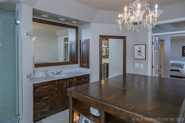 bathroom featuring vanity and a shower with shower door