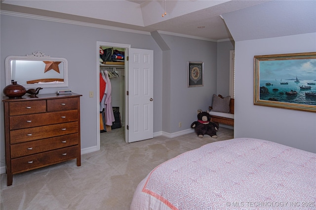 bedroom with crown molding, a closet, a spacious closet, and light carpet