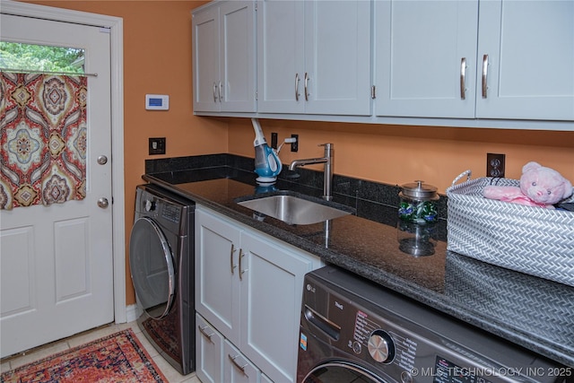 washroom with cabinets, washer / dryer, sink, and light tile patterned floors