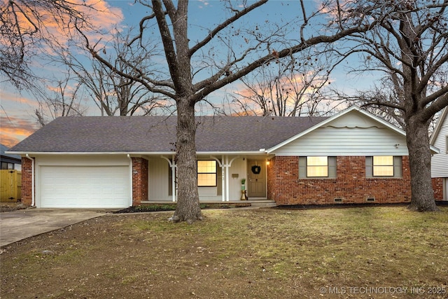 ranch-style home with a garage and a yard