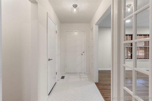 hallway with wood-type flooring