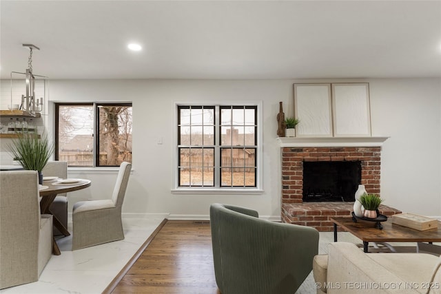 living room featuring dark hardwood / wood-style floors and a brick fireplace