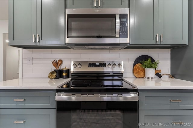 kitchen featuring stainless steel appliances and backsplash