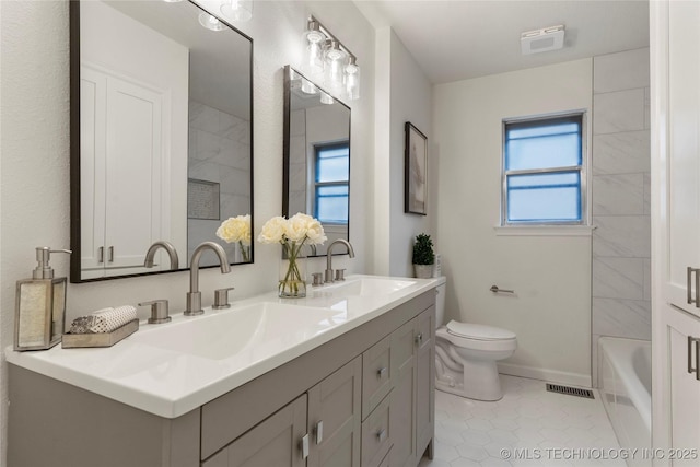 bathroom with vanity, toilet, and tile patterned flooring