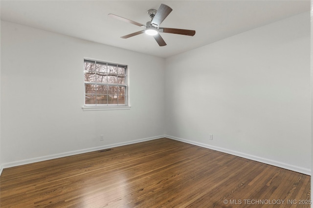 unfurnished room featuring ceiling fan and dark hardwood / wood-style flooring