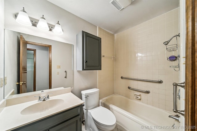 full bathroom with vanity, tiled shower / bath, and toilet