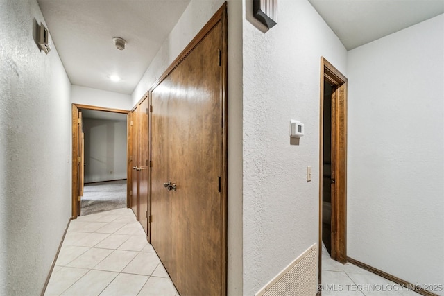 corridor with light tile patterned flooring