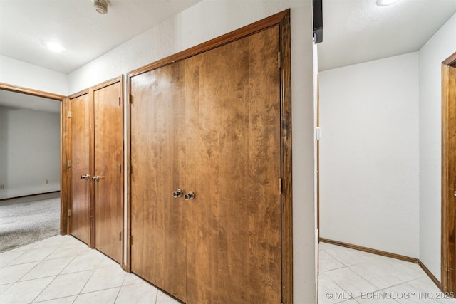 hallway featuring light tile patterned flooring