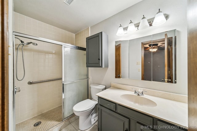 bathroom with vanity, toilet, a shower with shower door, and tile patterned flooring