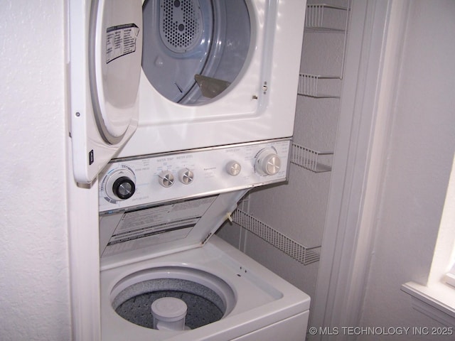 washroom with stacked washer / drying machine