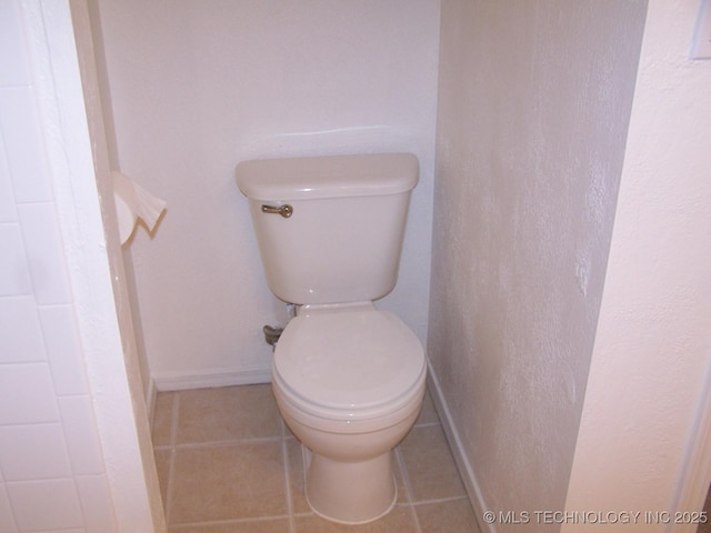 bathroom featuring tile patterned flooring and toilet