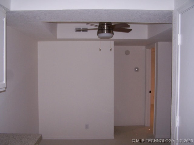 interior space with ceiling fan