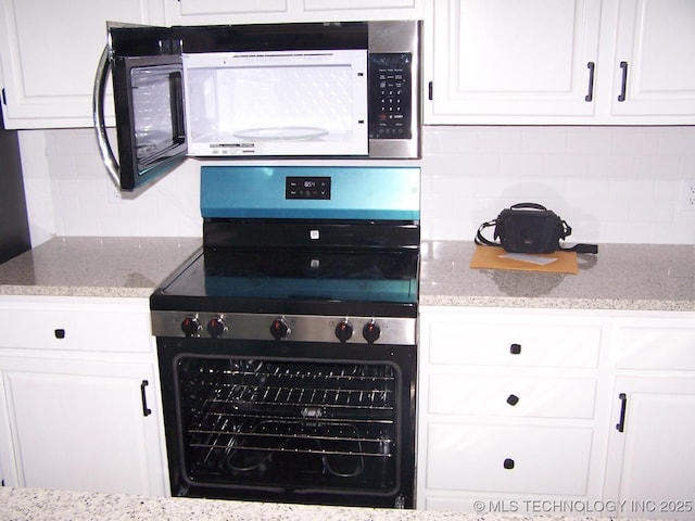 kitchen featuring white cabinets, light stone countertops, stainless steel range with electric cooktop, and backsplash