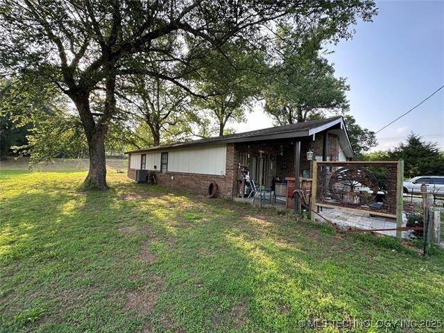 view of side of home featuring a yard