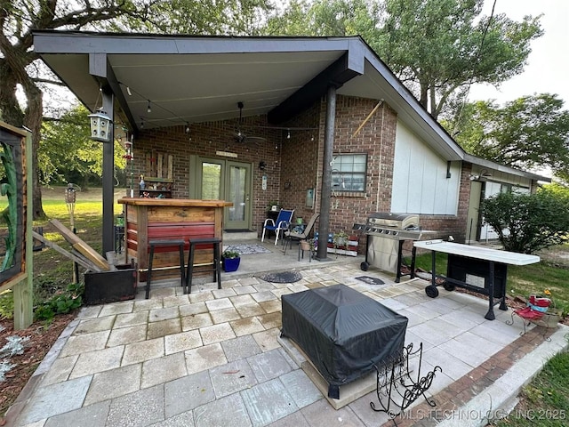 view of patio featuring a grill and exterior bar