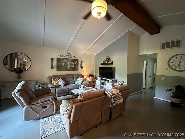 living room with ceiling fan, high vaulted ceiling, concrete flooring, and beamed ceiling