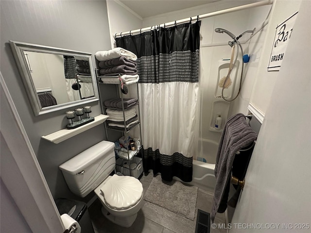 bathroom featuring toilet, tile patterned flooring, and shower / bath combo